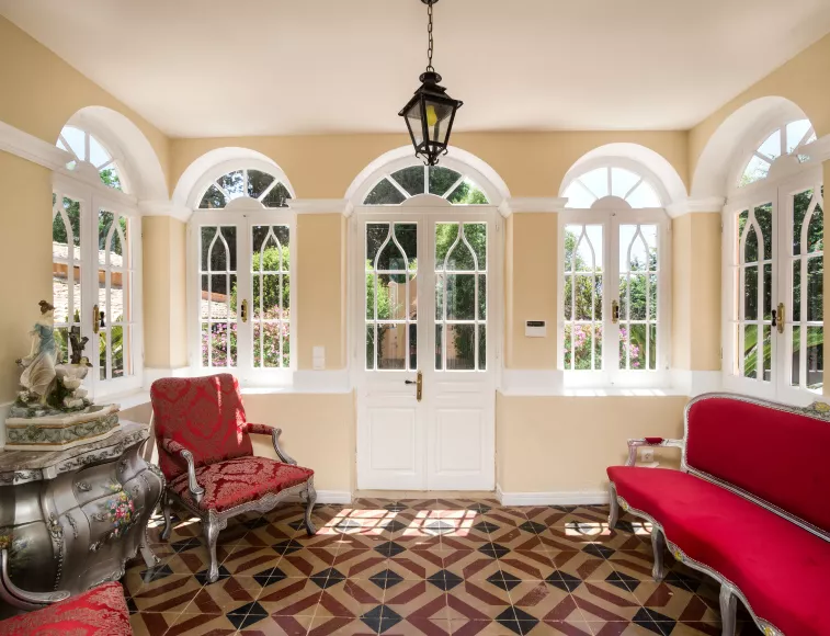 Corfiot arches windows fill the living room with bright sunlight.