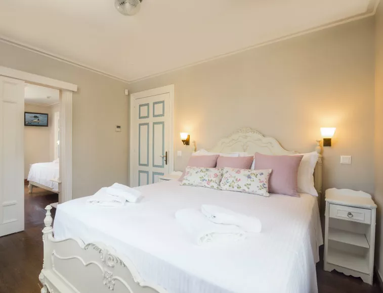 A luxurious sleep at the 1st floor’s master bedroom with a double bed and a romantic touch.